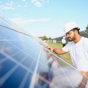 An image of a man maintaining a solar panel.
