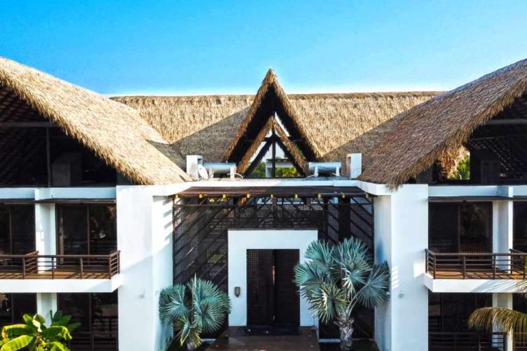 residential engineered thatch roofing on a home under a blue sky