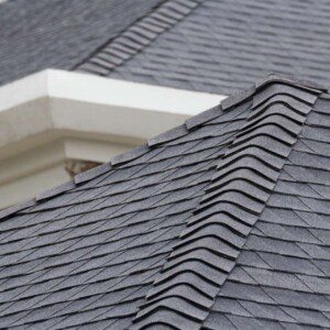 An image of an asphalt shingle roof on a home. 