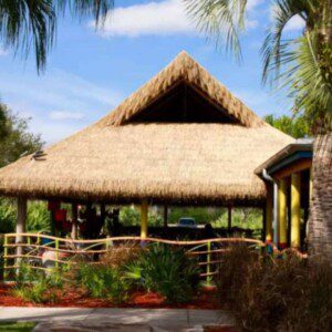 An image of a thatch-roofed building at a coastal resort.