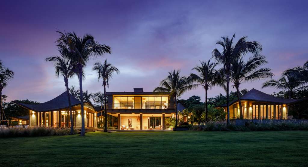 Casa Loro luxury tropical estate Pedasi Panama at dusk, Endureed bespoke engineered thatch roofing on multi-structure private residence, custom synthetic thatch blend for high-end coastal architecture Panama