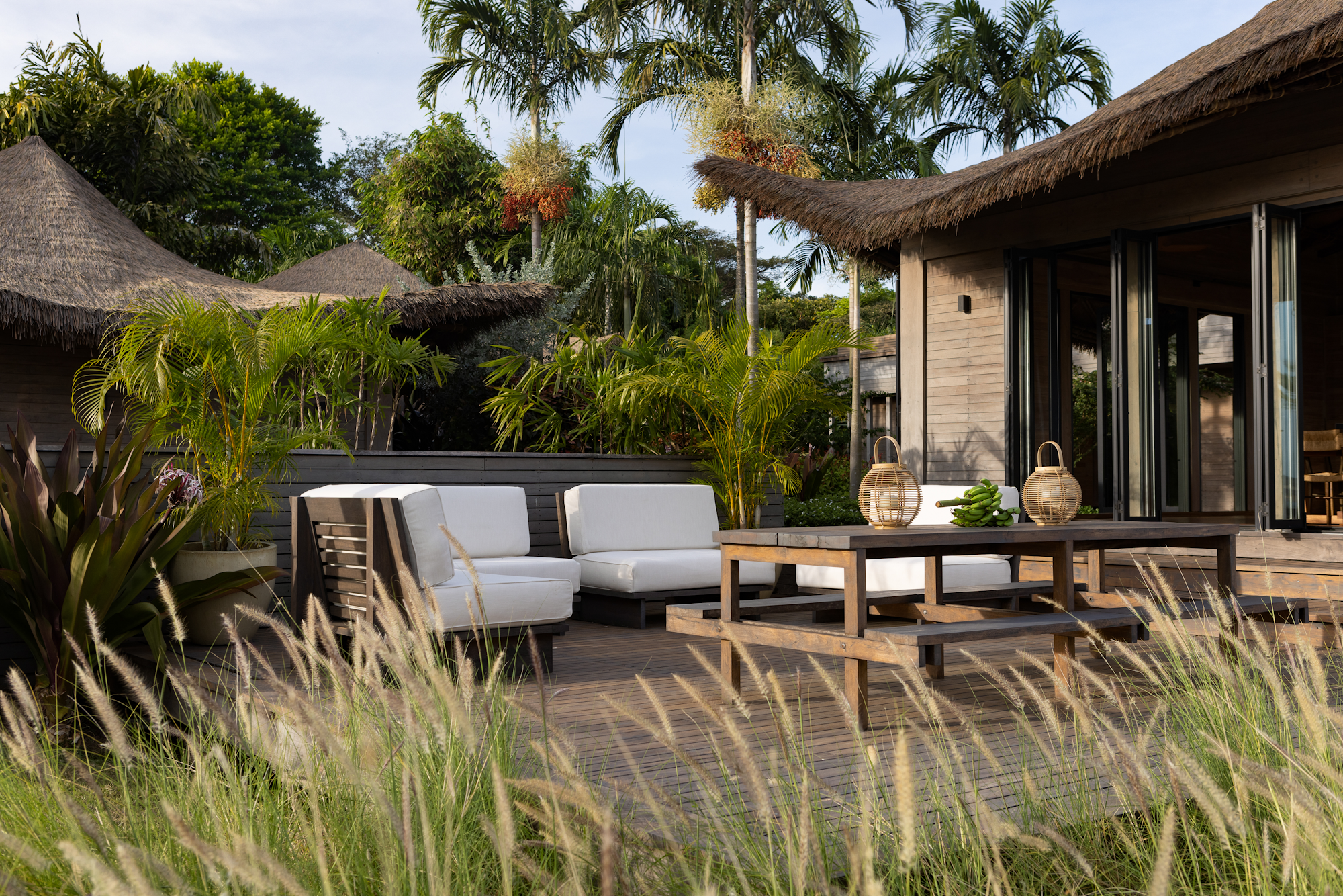 Endureed bespoke engineered thatch roofing on private villa at Casa Loro Pedasi Panama, custom synthetic thatch blend visible above tropical garden and plunge pool, luxury residential thatch architecture