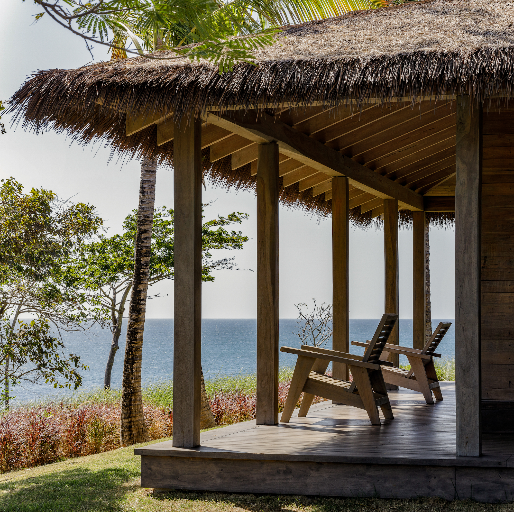 Covered oceanfront porch at Casa Loro Pedasi Panama with Endureed bespoke synthetic thatch roof and eave detail, custom engineered thatch blend on private luxury villa with Pacific Ocean view
