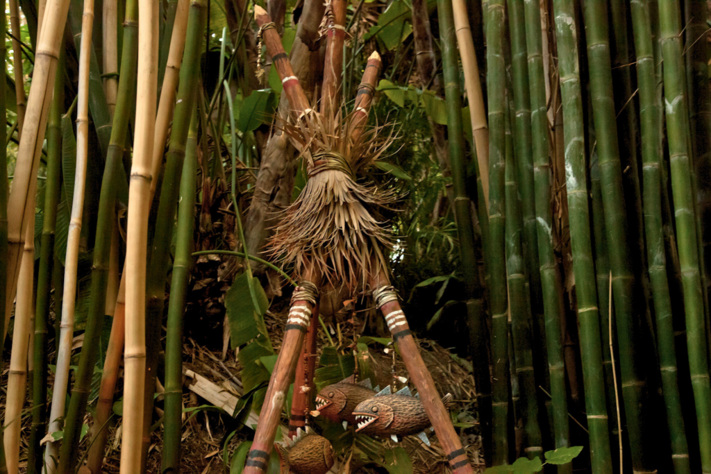 Endureed Premium Dominica synthetic thatch bundle detail amid bamboo grove at Disneyland Adventureland &mdash; craftsmanship detail of engineered thatch panel construction and binding