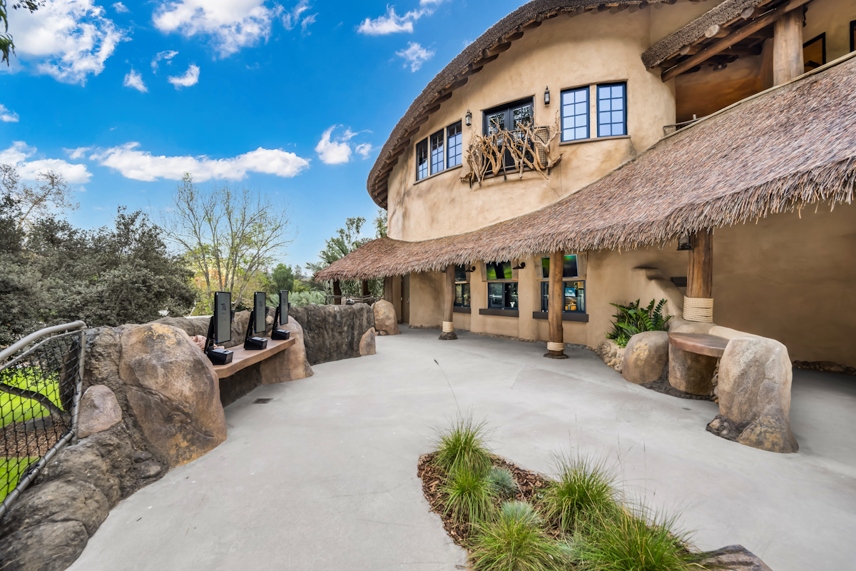Detail view of Endureed engineered thatch roof overhang and layered eave construction on Elephant Valley Safari Park lodge, showing texture depth and craftsmanship on commercial zoo project