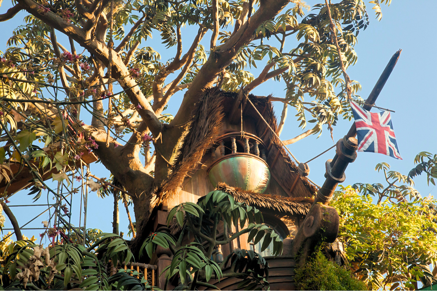 Endureed Premium Dominica engineered thatch roof on Swiss Family Treehouse structure at Disneyland Adventureland Anaheim &mdash; synthetic thatch integrated with tropical tree canopy