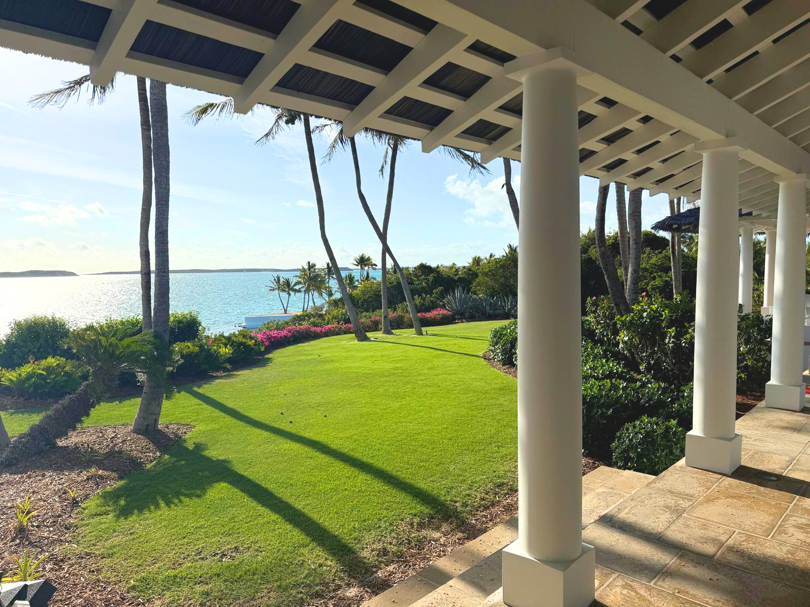 Endureed Kilimanjaro thatch roof installation on luxury Bahamas estate entrance, showing eave overhang and timber rafter detail