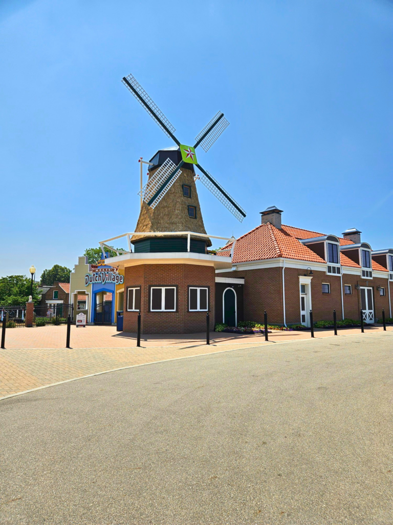 Endureed Somerset premium engineered thatch on Nelis Dutch Village windmill entrance Holland Michigan, synthetic thatch cladding on theme park landmark tower demonstrating durability and authentic texture in northern climate