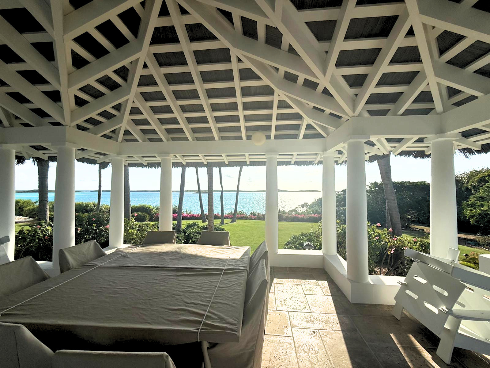 Endureed Kilimanjaro synthetic thatch ceiling panels on luxury poolside covered walkway leading to open pavilion, Goat Cay Bahamas