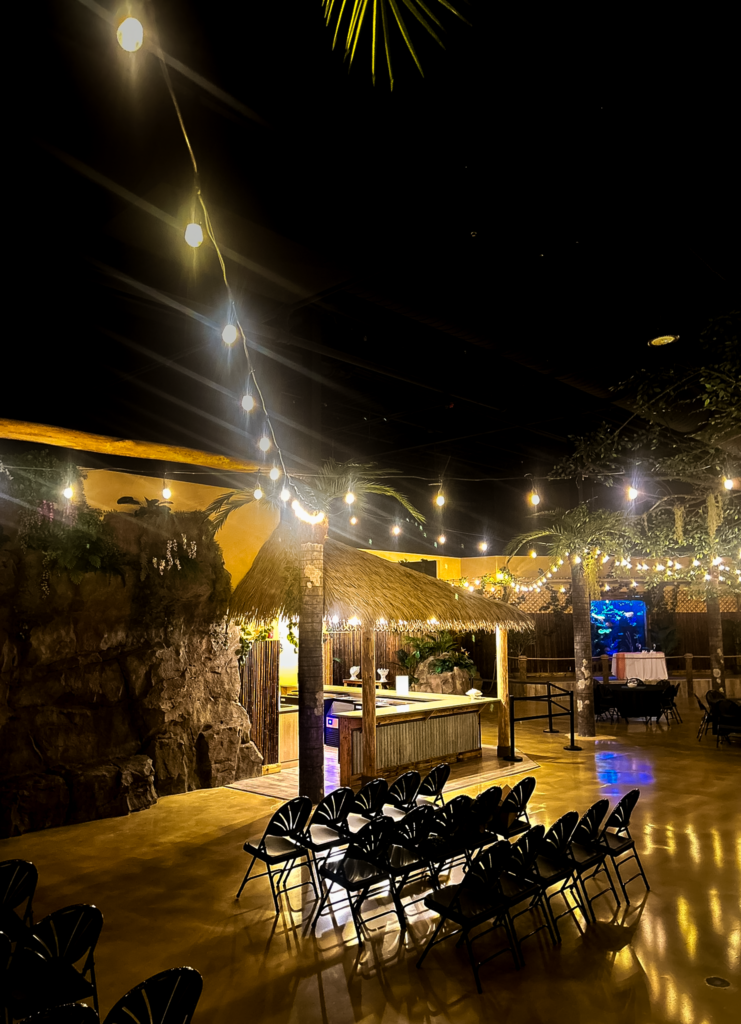 Commercial tiki hut with synthetic thatch roof installed in event venue