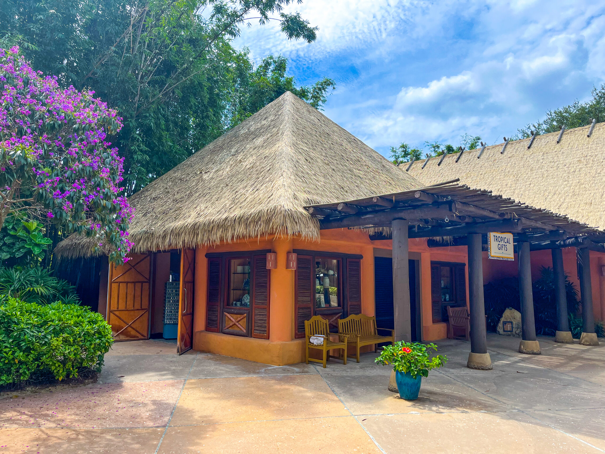 Endureed engineered thatch conical roof on retail structure at Discovery Cove Orlando, synthetic thatch for theme park commercial building with connected thatched pergola walkway