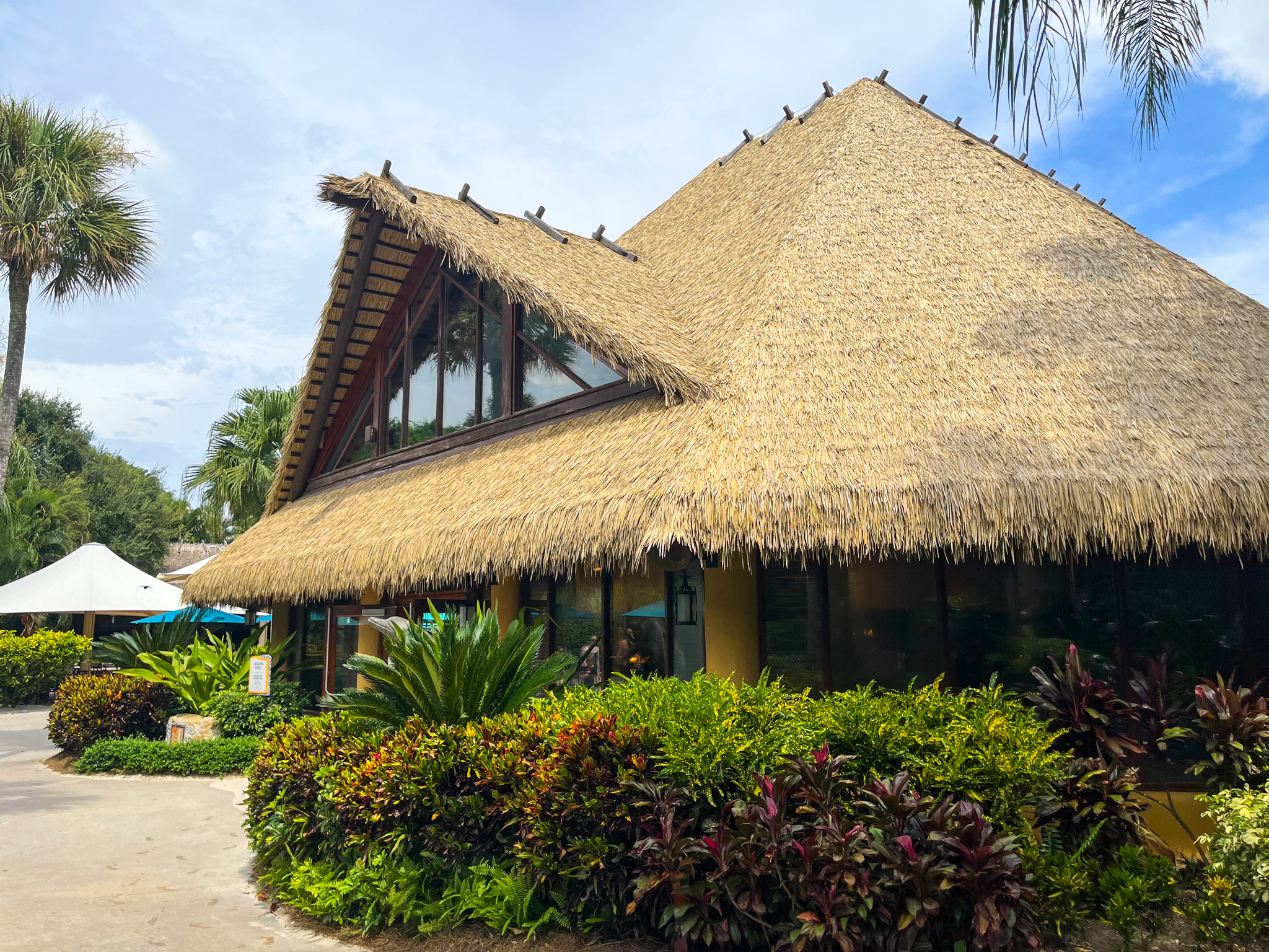 Endureed engineered thatch A-frame roof on main venue building at Discovery Cove Orlando, large-scale synthetic thatch installation for theme park hospitality and entertainment architecture