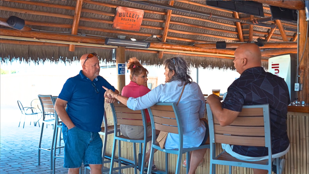 Guests relaxing at Oxford Downs tiki bar under Endureed Viva Thatch synthetic palm roof, Florida