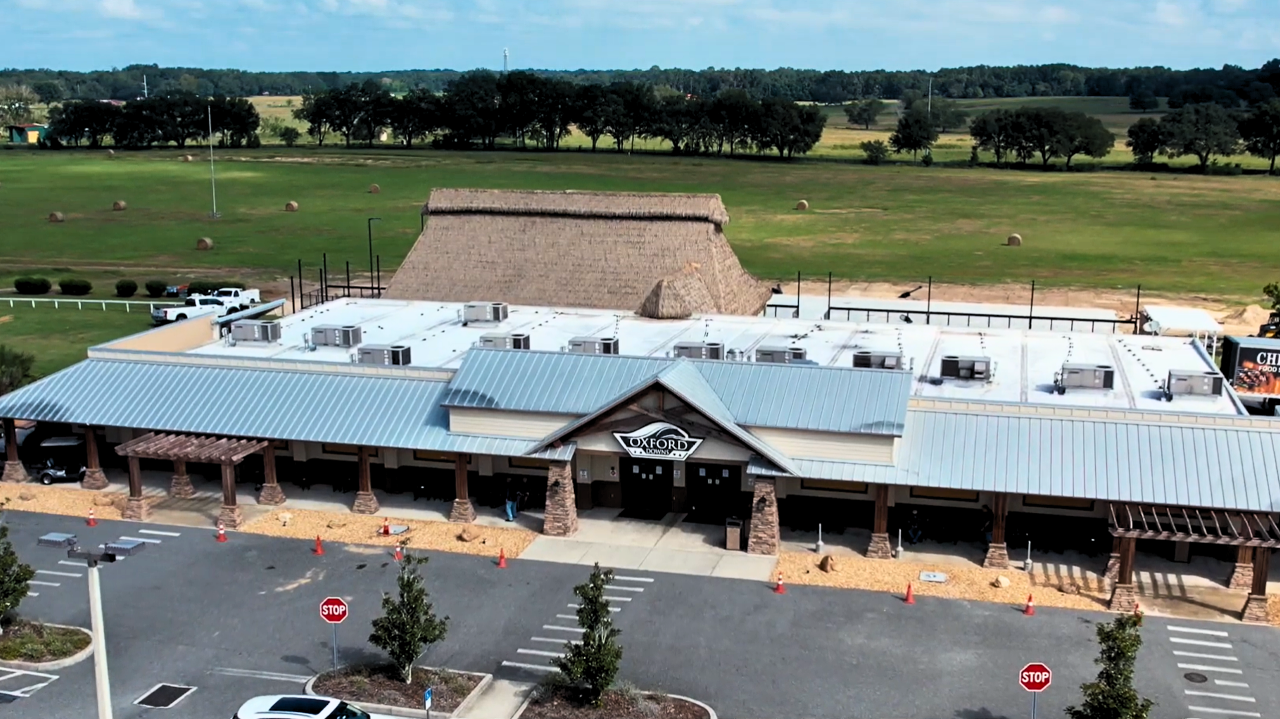 Aerial view of Oxford Downs entertainment complex with engineered palm thatch tiki structure, Florida