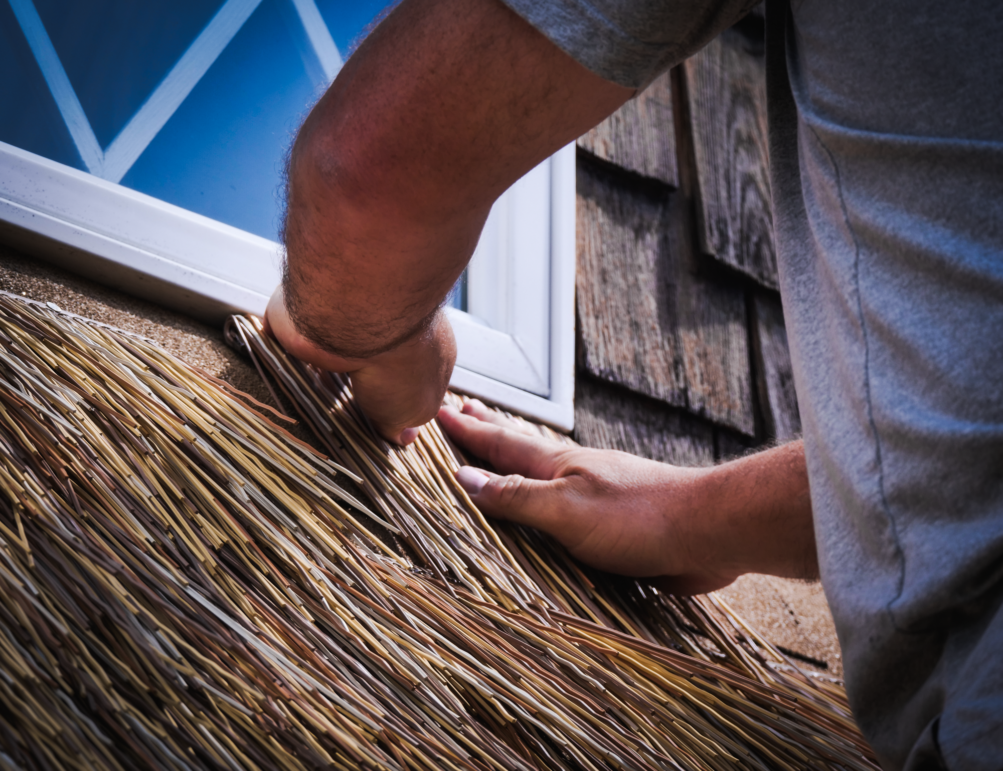 In defense of ancient craft close up on window engineered thatch install